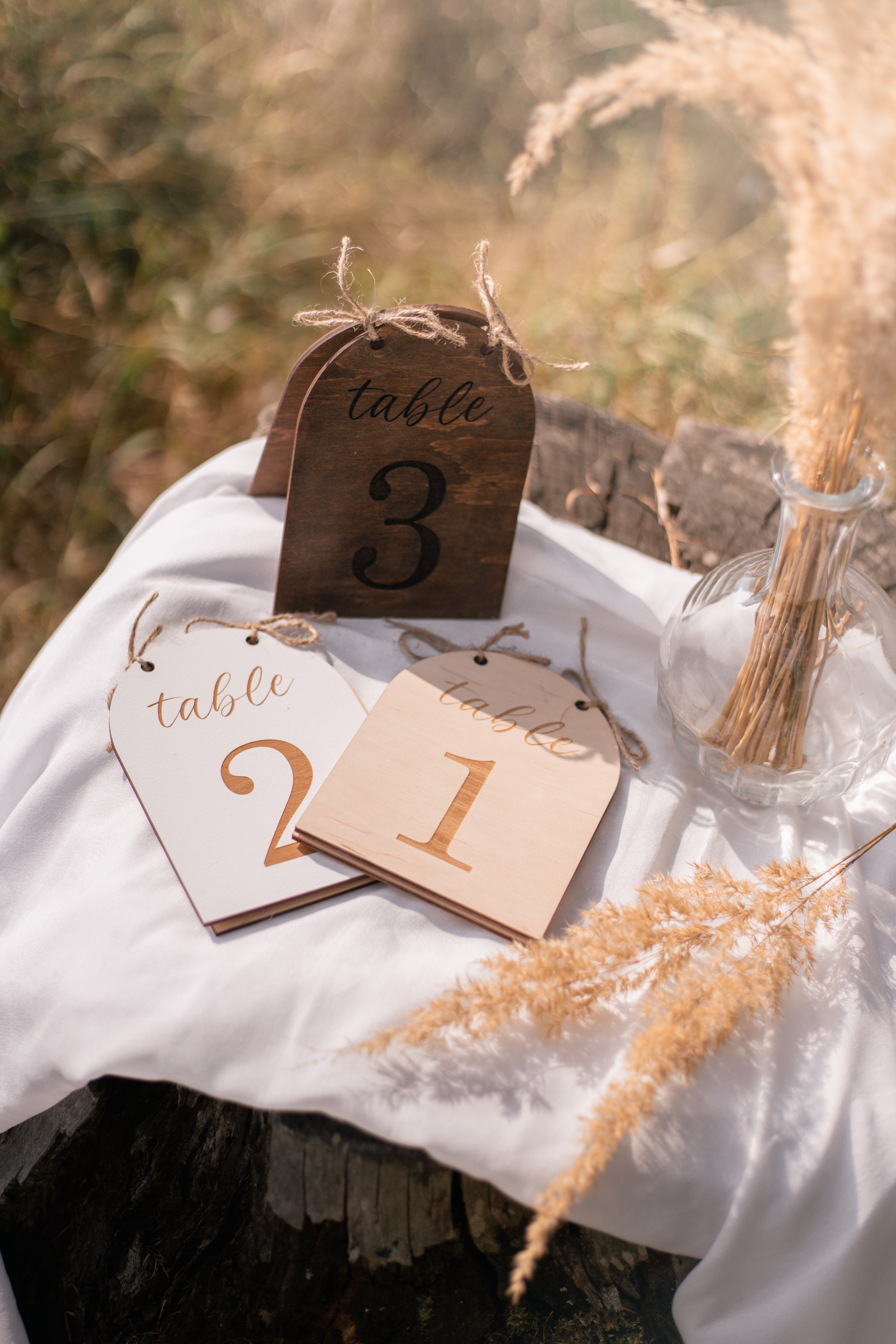 Handmade arch table numbers with jute bow laser-engraved
